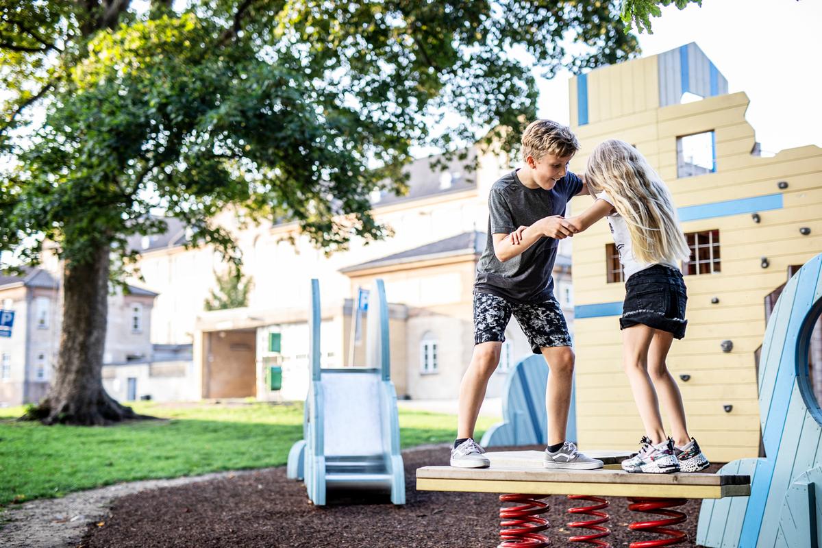 Children playing on a wobble board