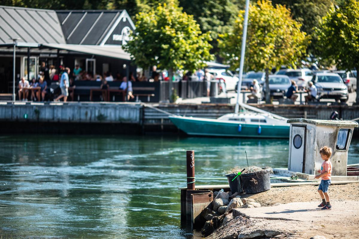 Boy standing by Norsminde harbour