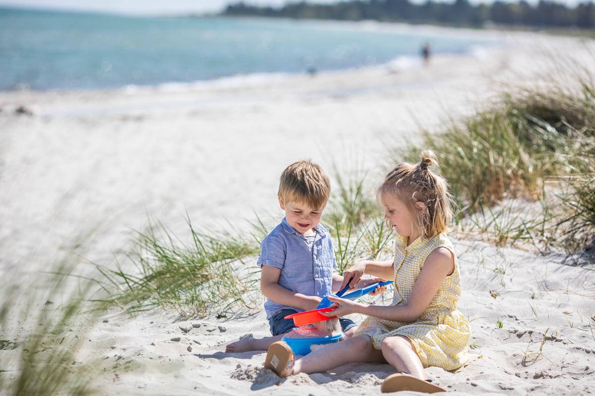 Kids are playing on the beach at Saksild