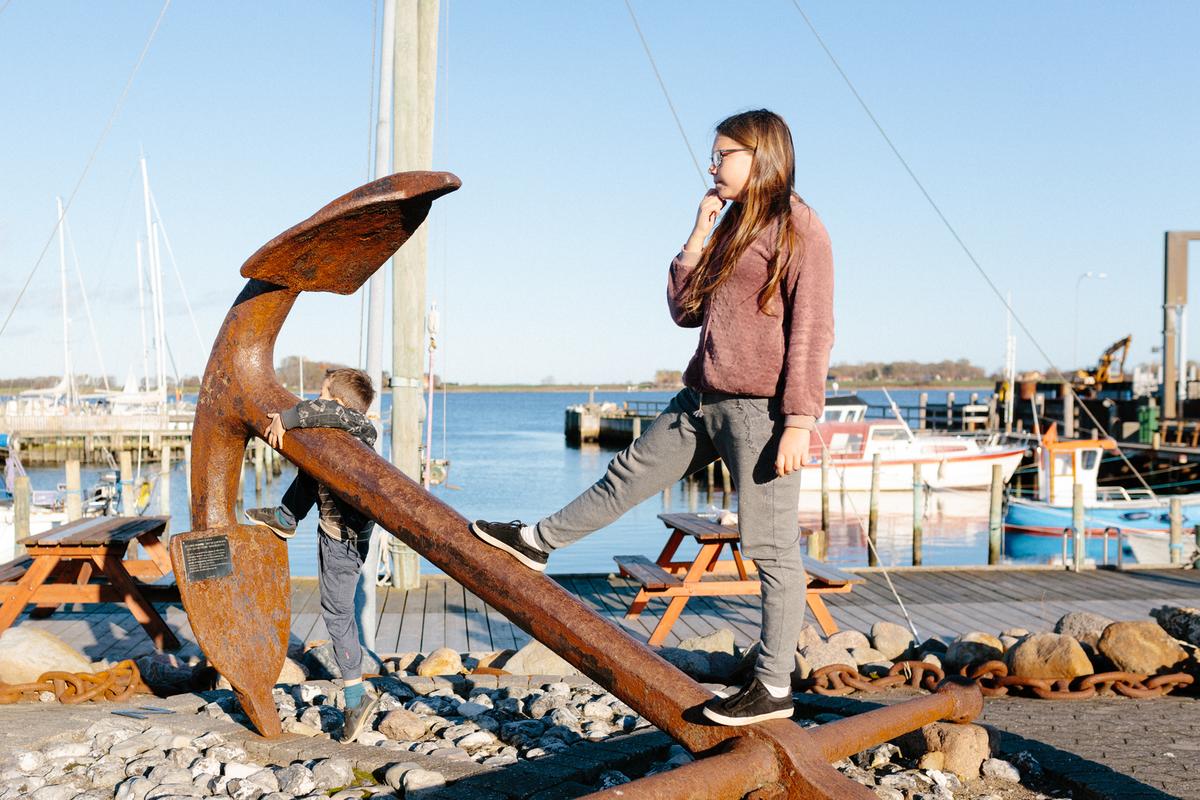 Girl is standing on the anker at Snaptun Harbour