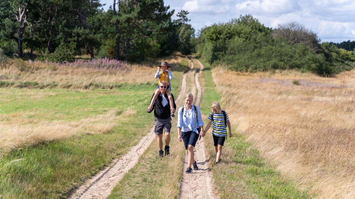 Family walking around Tunø attending The  Tunø Treasure Hunt