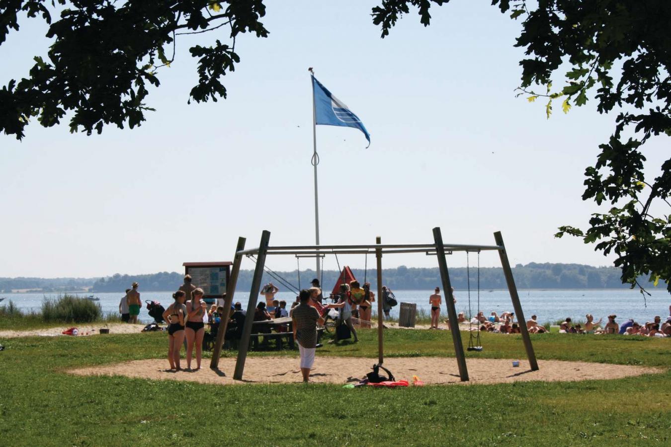 Children playing on the playground at Horsens City Camping at Husodde Beach in Horsens - part of the Coastal Land