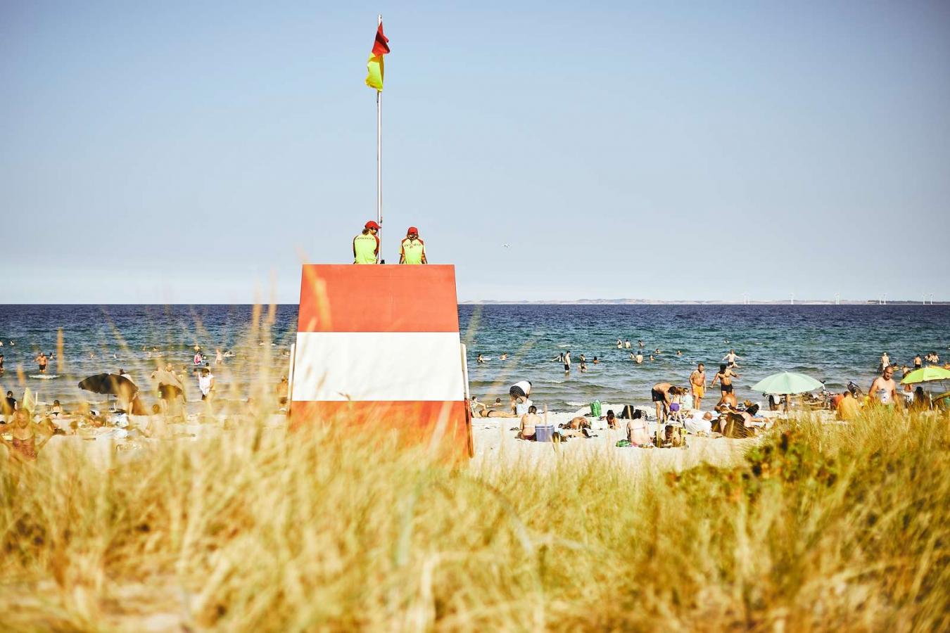 Lifeguard tower at Saksild Beach with guests on the beach