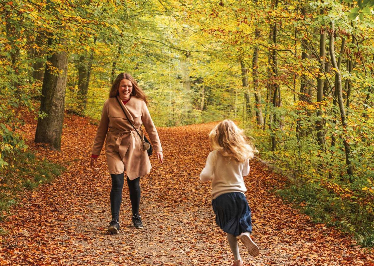 Mother and daughter in Åbjerg Forest by Bygholm Lake on an autumn day