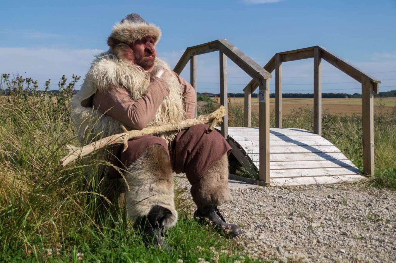 A troll is sitting by a bridge in the Fairytale Forest near Odder