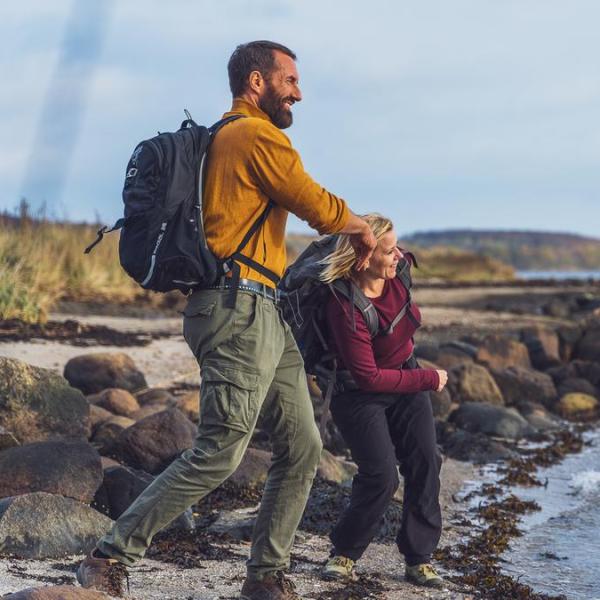 Two hikers skip stones at Horsens Fjord