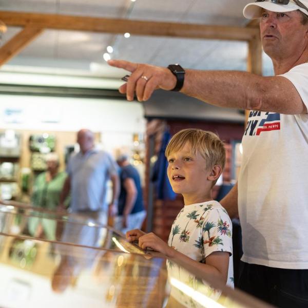 A boy and his father looking at a ship exhibit at Juelsminde Harbour Museum