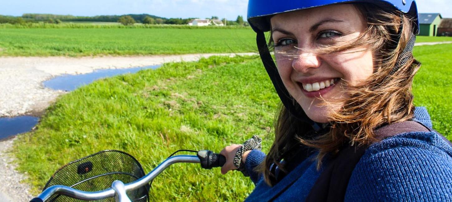 Travel blogger Melissa Villumsen taking a selfie while sitting on a bicycle on Endelave