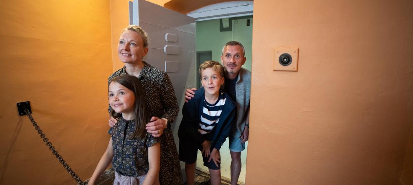 Family looks into a prison cell