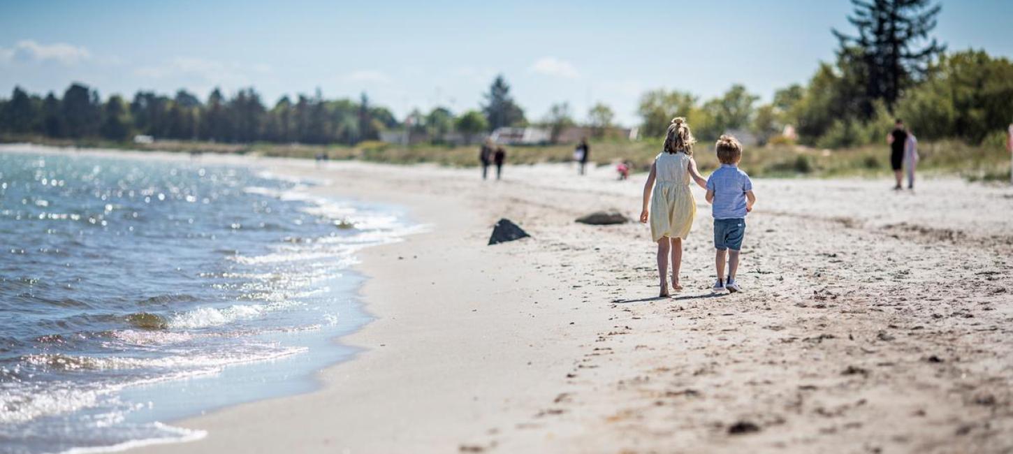 Children walking on Saksild Beach