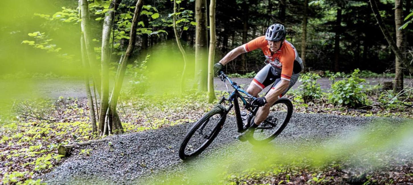 A man on a mountain bike on a curve in the trail in Bisgaard Forest in Odder