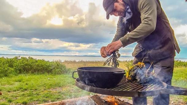 Man making food outdoor with fire