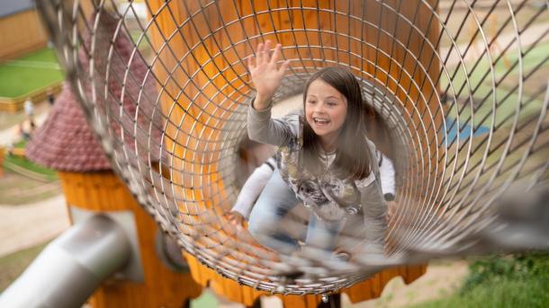 Girl in the play tower in Juelsminde Nature Play Park