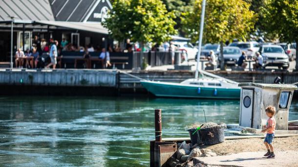 Boy standing by Norsminde harbour