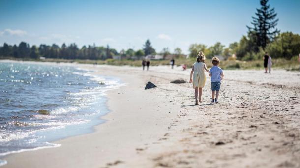 Children walking on Saksild Beach