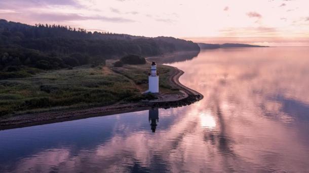 View of the coastal line and lighthouse in the area of Hotel Vejlefjord in the coastal land