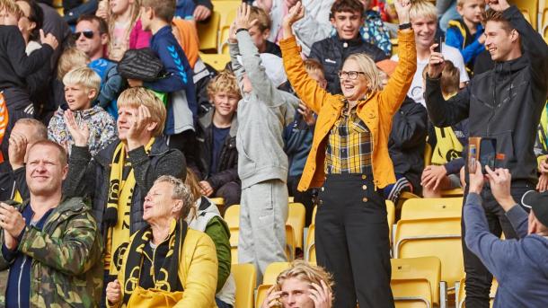 Happy football fans stranding on one of the grandstands at CASA Arena Horsens
