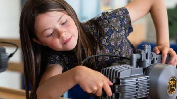 Girl playing with a engine at the Industrial Museum in Horsens