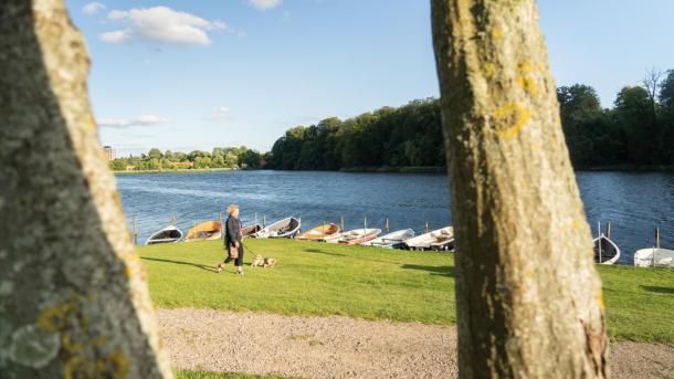 Woman walking her dog by Bygholm Lake