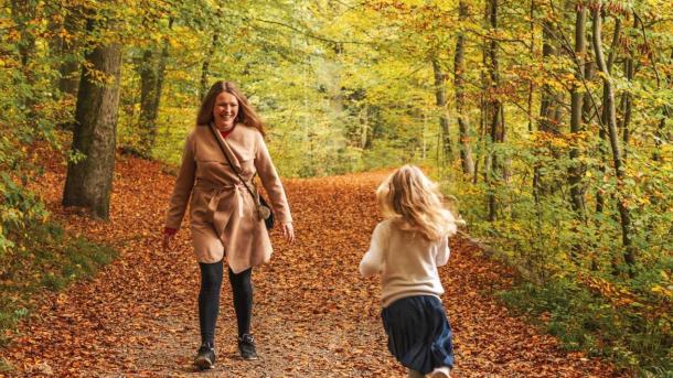 Mother and daughter in Åbjerg Forest by Bygholm Lake on an autumn day