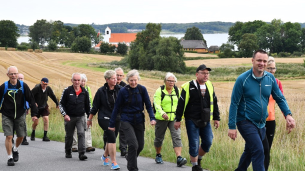 Group from Horsens Fodslaw hiking on a country road at As Vig