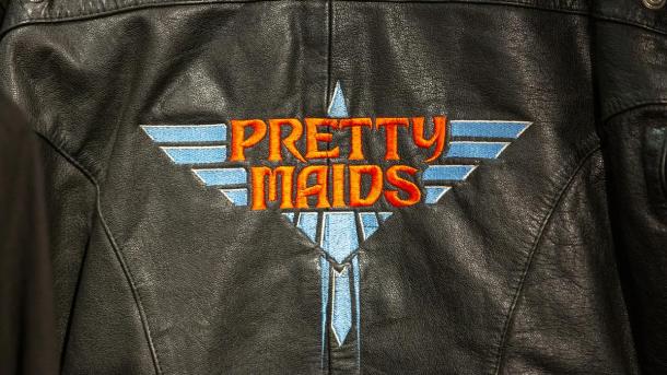 Black leather jacket with Pretty Maids logo on the back in blue and red