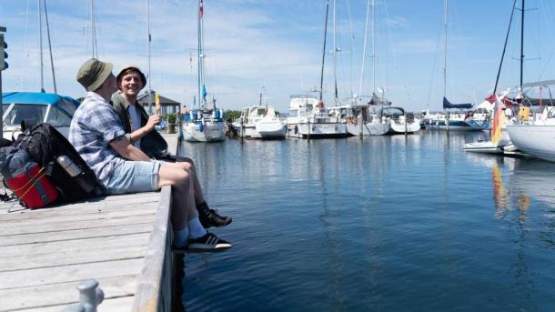 Two hikers eating ice cream on the jetty at Snaptun Marina