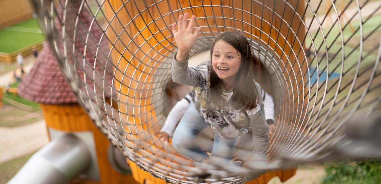 Girl in the play tower in Juelsminde Nature Play Park