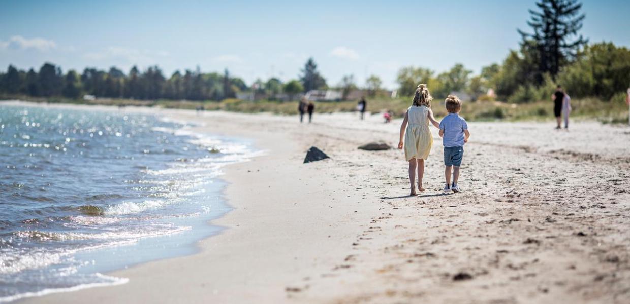 Children walking on Saksild Beach