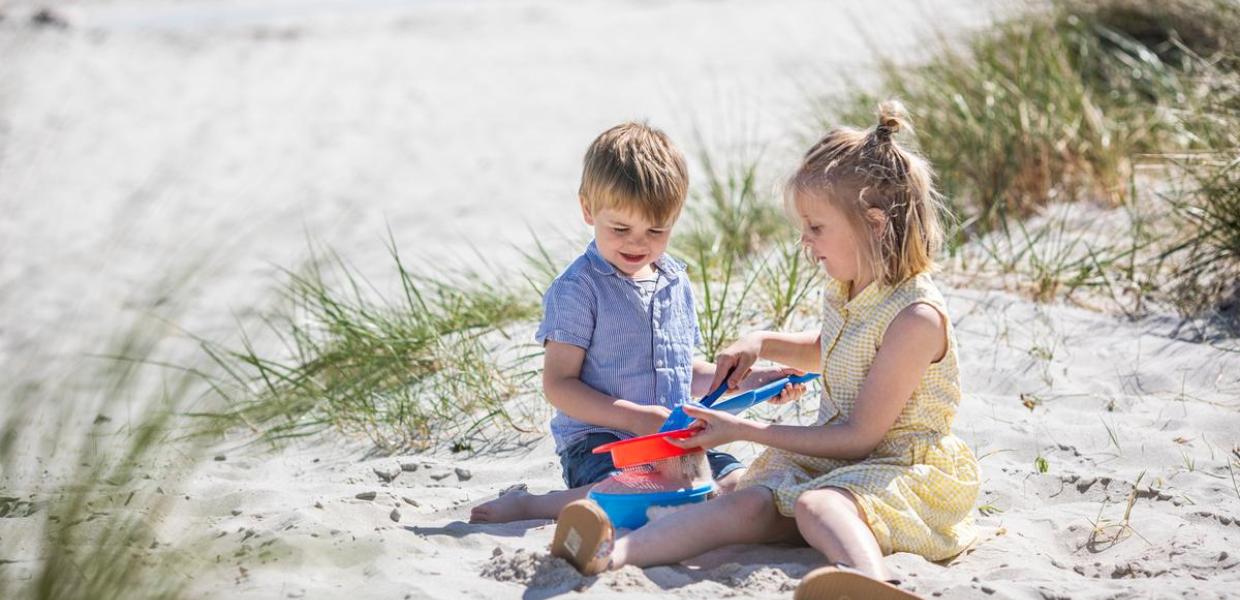 Kids are playing on the beach at Saksild