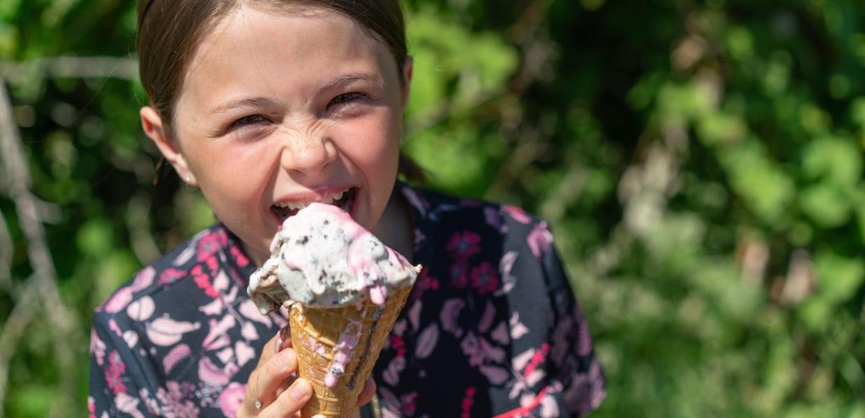 Girl eats a ice cream in the coastal land