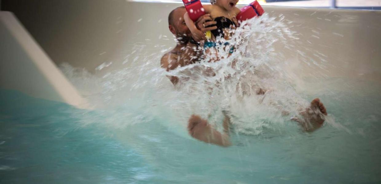 Father and daughter flying out of the water slide at Valhalla, Hou