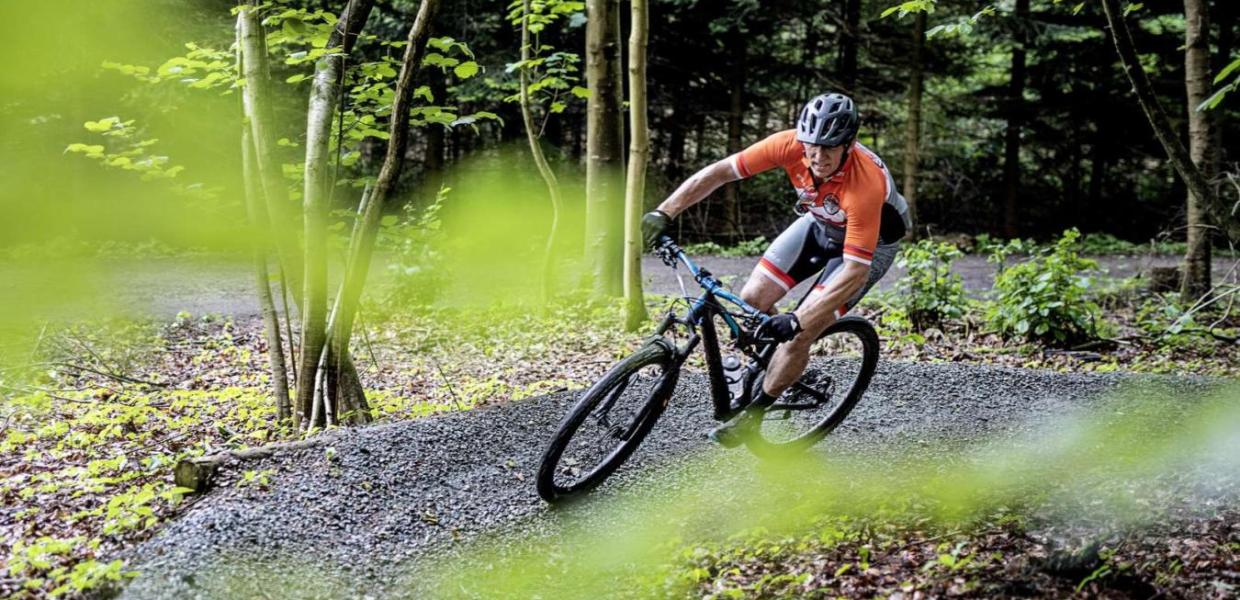 A man on a mountain bike on a curve in the trail in Bisgaard Forest in Odder