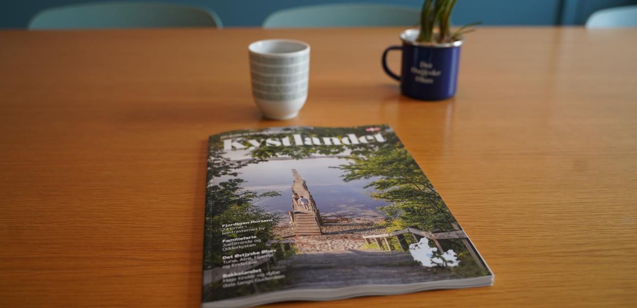 Kystlandets velkomstguide 2026 på et bord