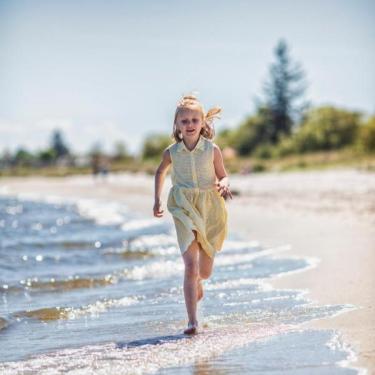 Girl are running on the beach at Saksild