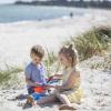 Children playing on the white sandy beach in Saksild