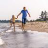 Father and daughter on the water's edge at Saksild Beach