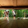 Two friends looking into a shelter in Destination Coastal Land