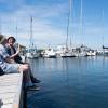 Two hikers eating ice cream on the jetty at Snaptun Marina