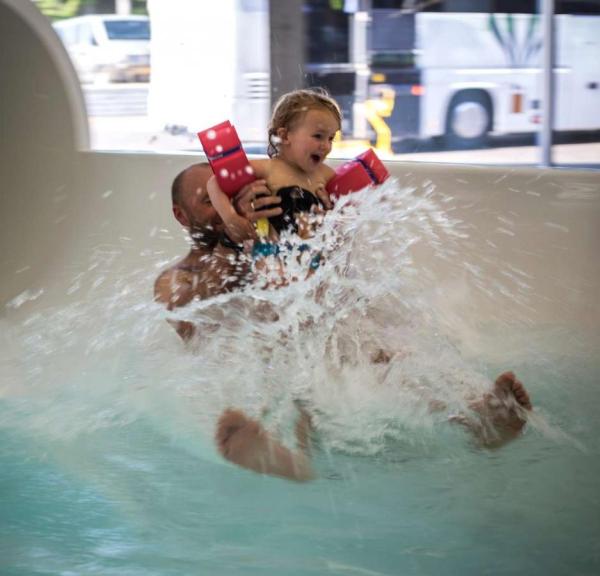 Father and daughter flying out of the water slide at Valhalla, Hou