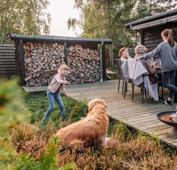 Family hanging out on the terrace of a holiday house from Feriepartner in the Coastal Land on the eastern coastline of the peninsula of Jutland in Denmark