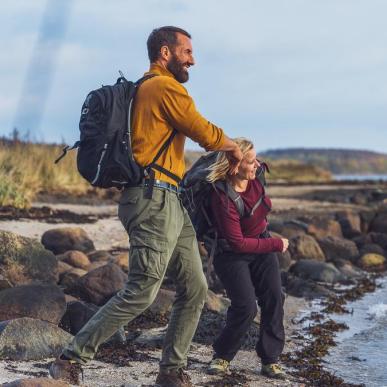 Two hikers skip stones at Horsens Fjord