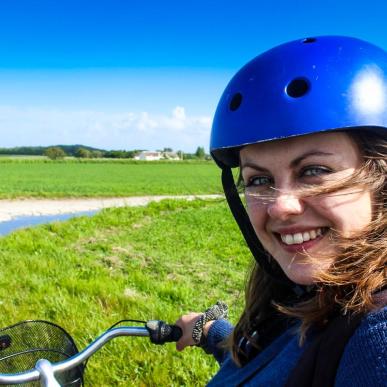 Travel blogger Melissa Villumsen taking a selfie while sitting on a bicycle on Endelave