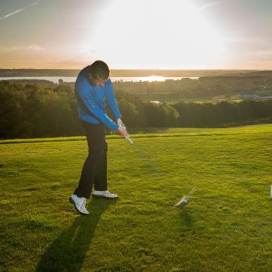 Golfer hit a golfball at Stensballegaard Golfclub in Horsens