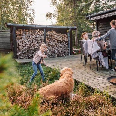 Family hanging out on the terrace of a holiday house from Feriepartner in the Coastal Land on the eastern coastline of the peninsula of Jutland in Denmark