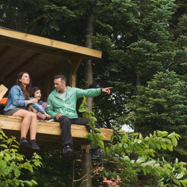 Mother, daughter and father in a shelter at Holmely - part of Destination Coastal Land