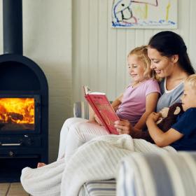 an Mother is reading a story to her children in a vacation home in the coastal land