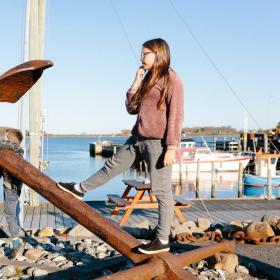 Girl is standing on the anker at Snaptun Harbour