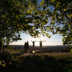 Family standing on the top of The Sugar Loaf in the coastal land