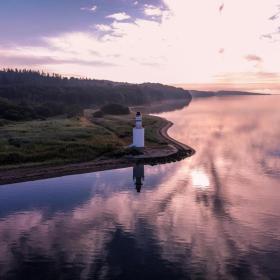 View of the coastal line and lighthouse in the area of Hotel Vejlefjord in the coastal land